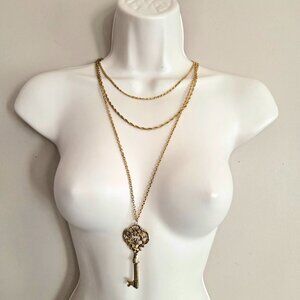 Sumthing Special skeleton key pendant on 3 layered gold color chain.